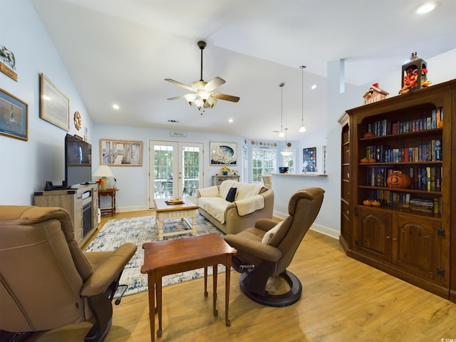 living room with french doors, vaulted ceiling, light wood-type flooring, and ceiling fan