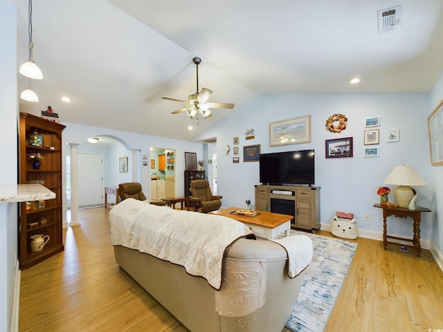 living room with vaulted ceiling, ornate columns, light wood-type flooring, and ceiling fan