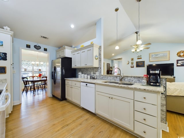 kitchen featuring lofted ceiling, dishwasher, sink, white cabinets, and light hardwood / wood-style floors