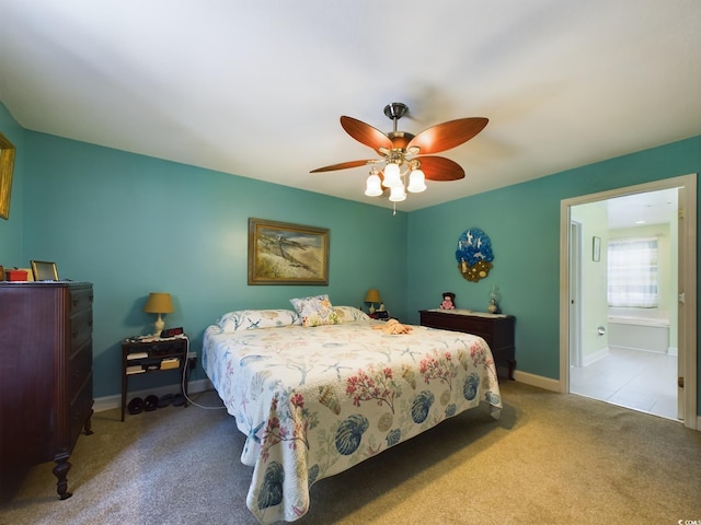 carpeted bedroom featuring connected bathroom and ceiling fan