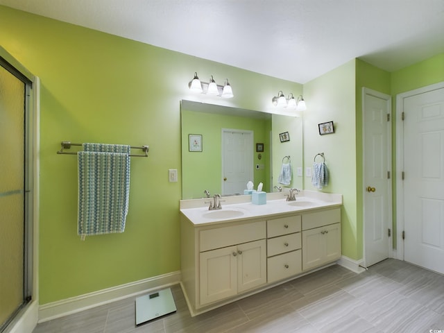 bathroom with vanity and a shower with shower door