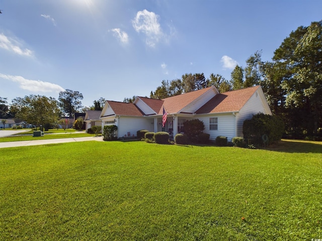 ranch-style home with a garage and a front lawn