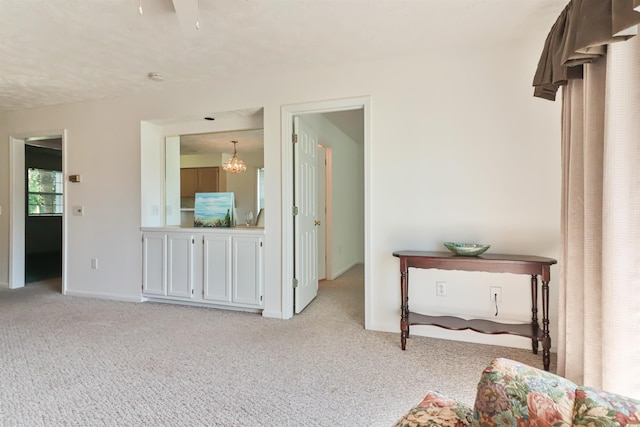 carpeted bedroom with a notable chandelier