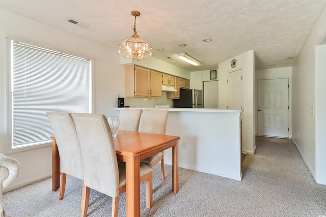 dining space with a notable chandelier and light colored carpet