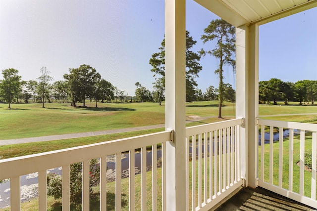 wooden terrace featuring a lawn