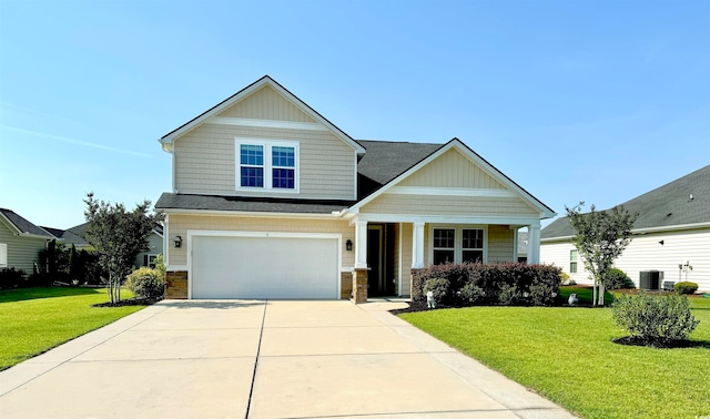 craftsman inspired home featuring a garage, central AC unit, and a front lawn