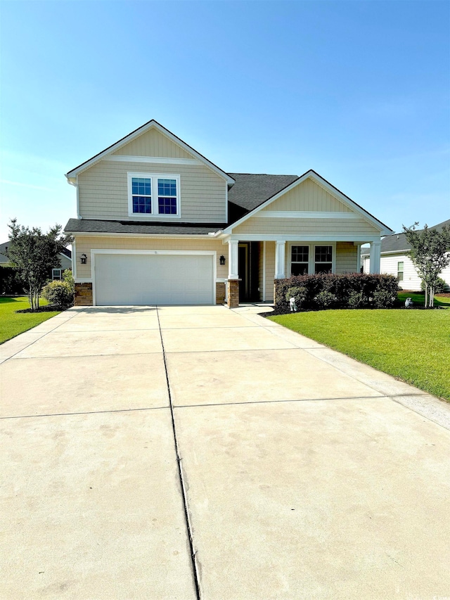 view of front facade featuring a garage and a front lawn