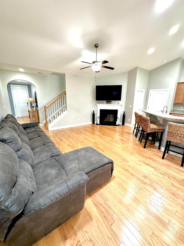 living room featuring ceiling fan and light hardwood / wood-style flooring