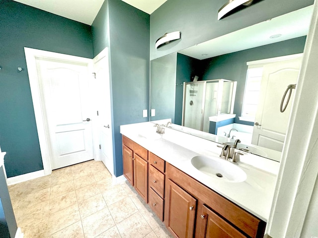 bathroom featuring tile floors, independent shower and bath, large vanity, and double sink