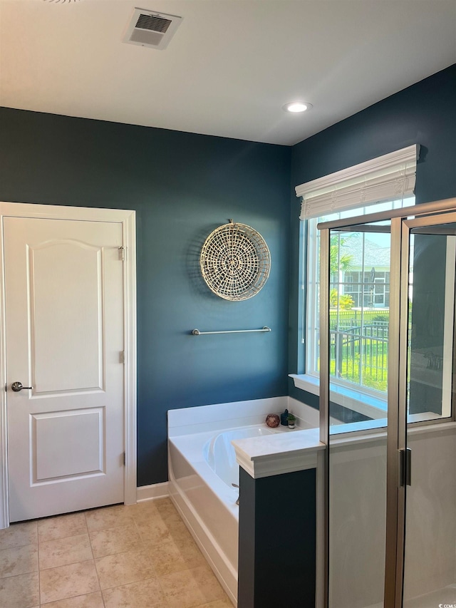 bathroom with a bathtub and tile flooring