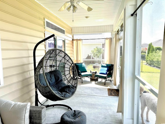 sunroom / solarium with ceiling fan and wood ceiling