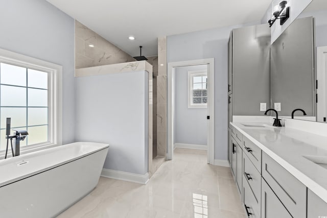 bathroom with vanity and shower with separate bathtub