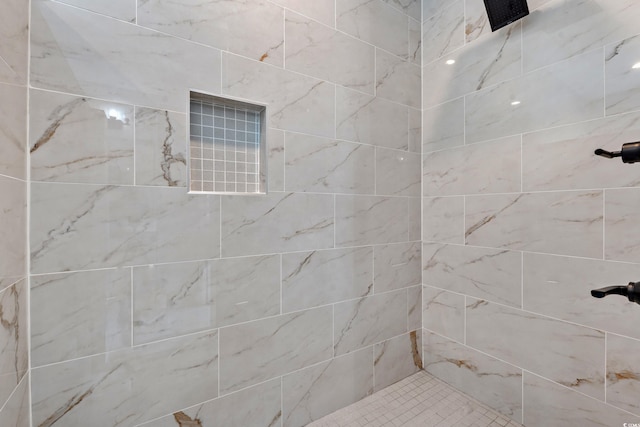 bathroom with tiled shower