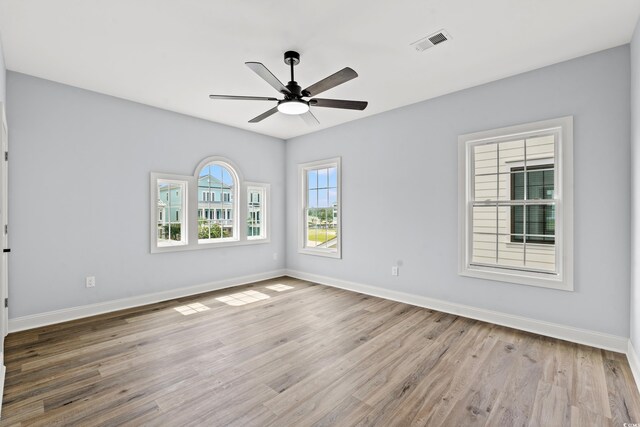 empty room featuring ceiling fan and light hardwood / wood-style floors