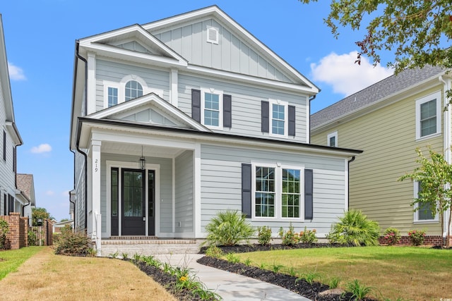 view of front facade with a front lawn and a porch