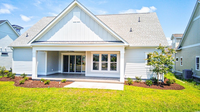 rear view of house featuring central AC, a patio, and a lawn