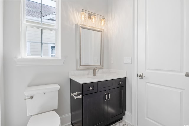 bathroom featuring vanity and toilet