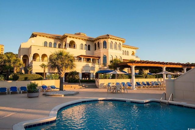 view of pool with a pergola and a patio area