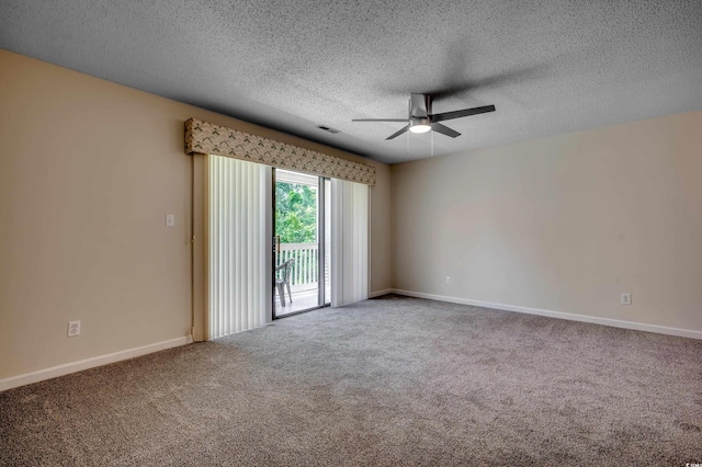 carpeted spare room featuring ceiling fan and a textured ceiling