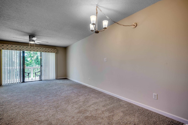 spare room with ceiling fan with notable chandelier, a textured ceiling, and carpet flooring