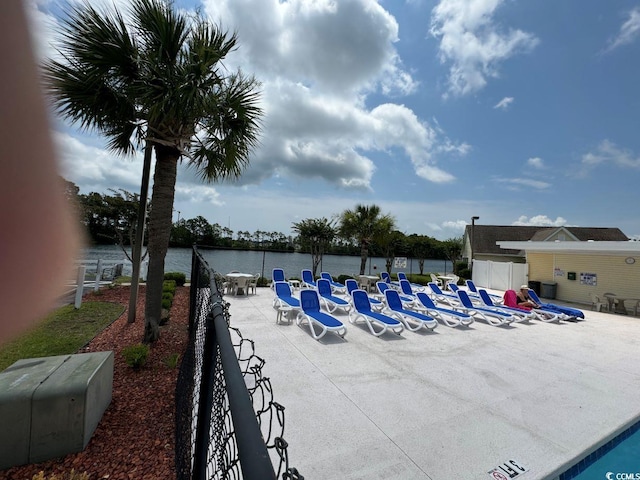 view of swimming pool featuring a water view