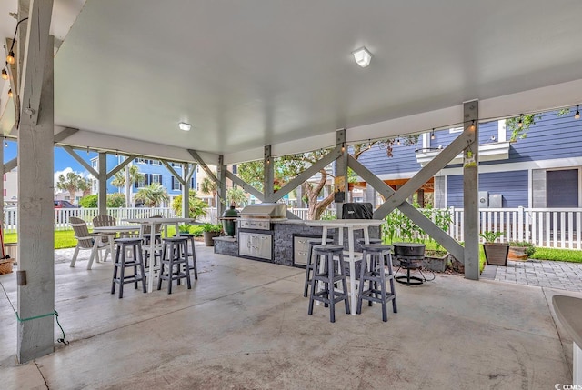 view of patio / terrace with exterior kitchen and a grill