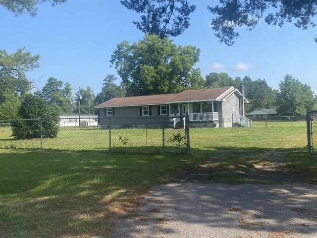 view of front of home with a porch and a front yard