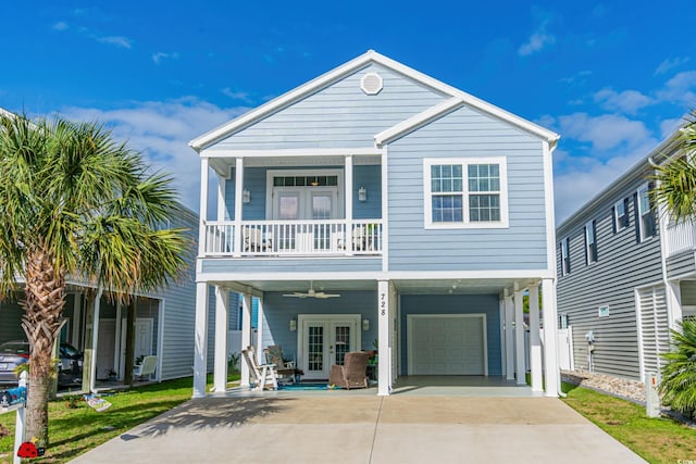 beach home featuring ceiling fan, french doors, a balcony, a garage, and a porch