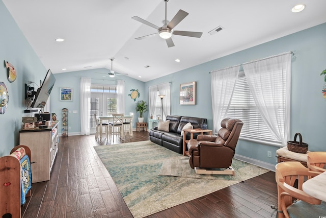 living room featuring dark hardwood / wood-style floors, vaulted ceiling, and ceiling fan