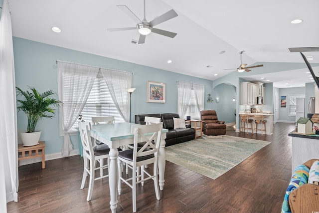 dining space featuring dark hardwood / wood-style flooring, vaulted ceiling, and ceiling fan