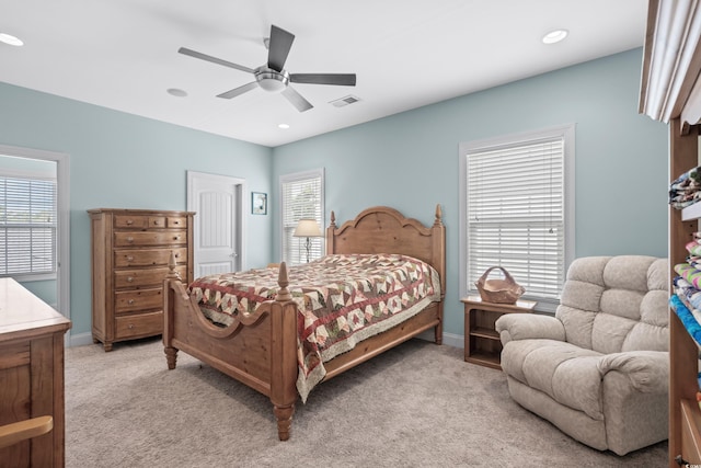 bedroom with ceiling fan and light colored carpet