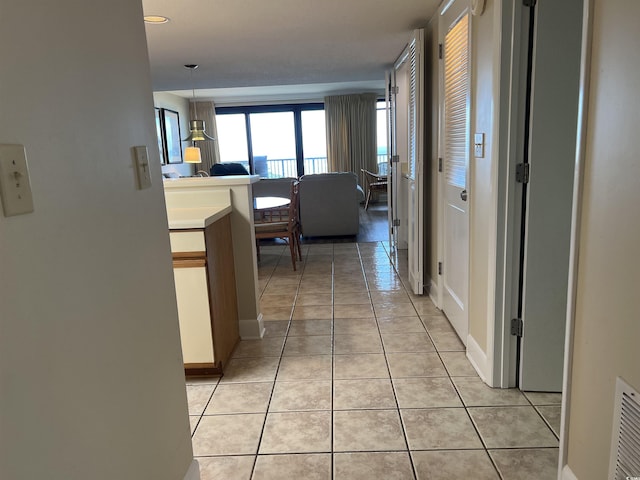 hallway with light tile patterned floors and visible vents