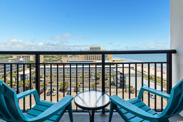 balcony with a water view and a beach view