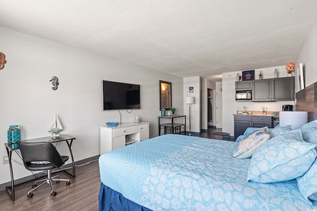 bedroom with dark hardwood / wood-style flooring and sink