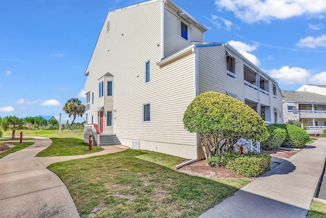 view of side of property with a lawn