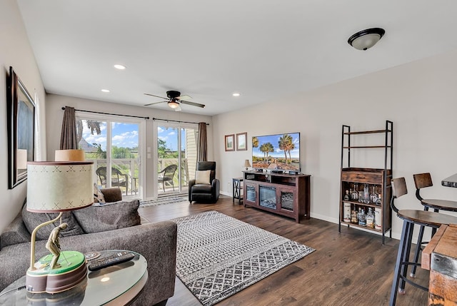 living room with dark wood-type flooring and ceiling fan