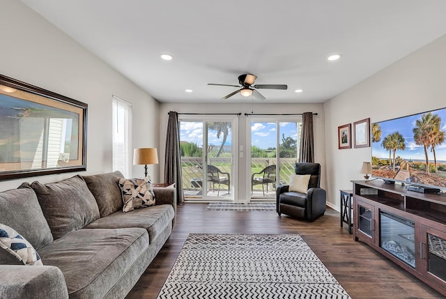 living room featuring ceiling fan, a wealth of natural light, and dark hardwood / wood-style flooring