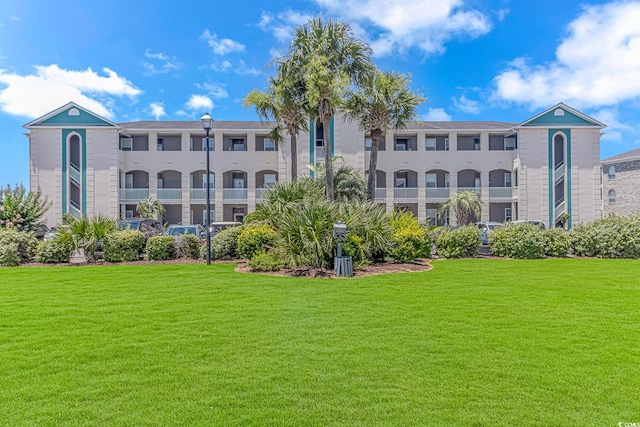 exterior space with a balcony and a yard