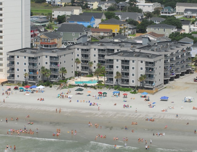 bird's eye view with a water view and a beach view