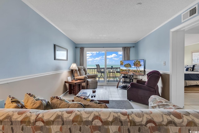 living room with crown molding, a textured ceiling, and light tile floors