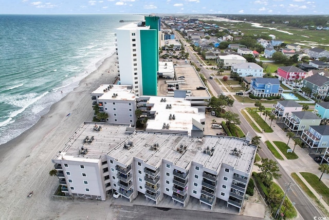 birds eye view of property with a beach view and a water view