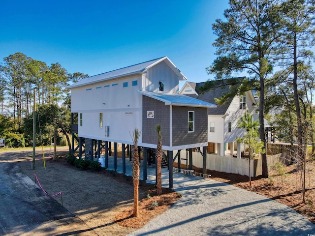 view of front of property featuring a carport, metal roof, and driveway