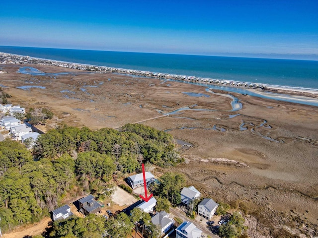 birds eye view of property with a water view and a beach view