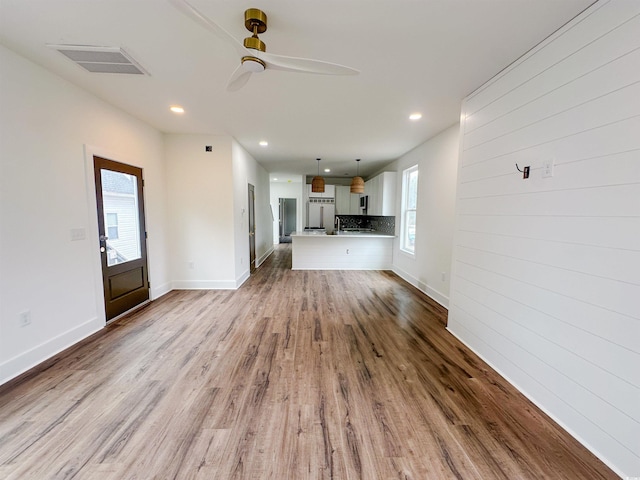 unfurnished living room featuring ceiling fan, light wood-style flooring, recessed lighting, visible vents, and baseboards