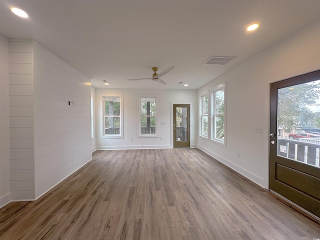 unfurnished living room featuring recessed lighting, visible vents, ceiling fan, wood finished floors, and baseboards