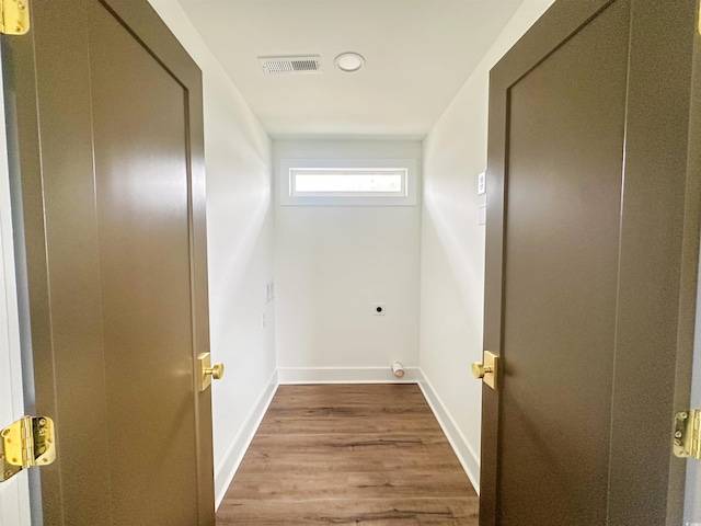 washroom featuring laundry area, visible vents, baseboards, light wood-style floors, and electric dryer hookup