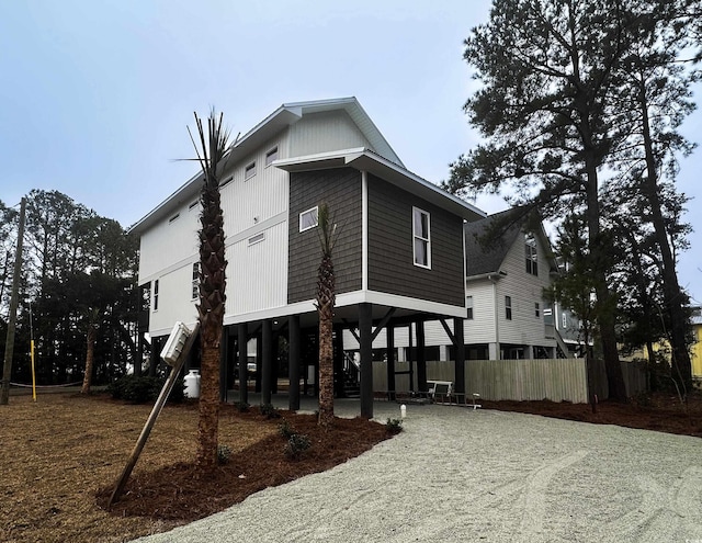 view of home's exterior featuring fence and a carport