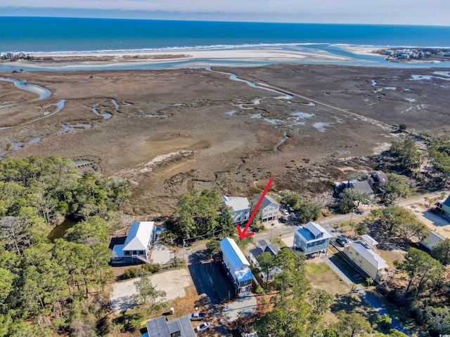 drone / aerial view featuring a beach view and a water view