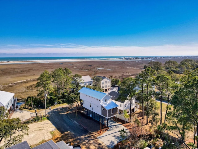 drone / aerial view featuring a water view and a view of the beach