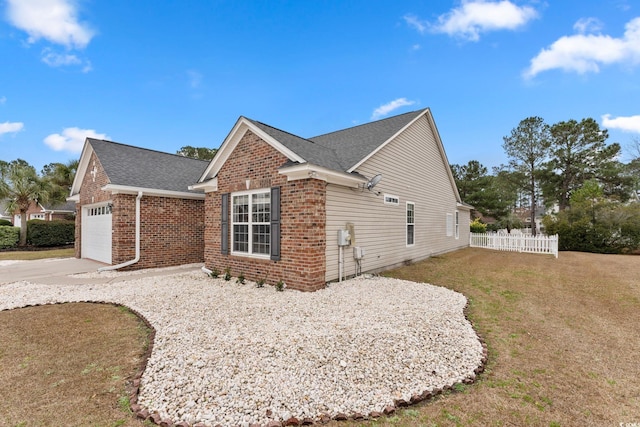 view of home's exterior featuring a yard and a garage